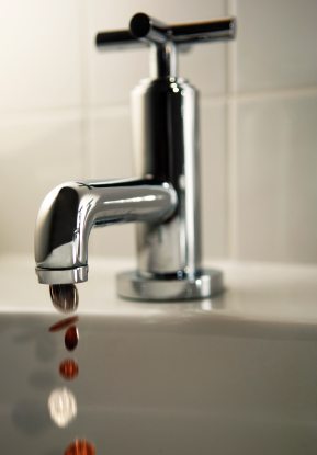 cash flow : picture of a tap with coins coming out of it instead of water