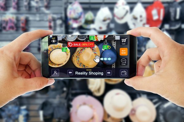 Augmented reality marketing in Department store. Hand holding smart phone use AR application to shoping online, check information and promotion.
