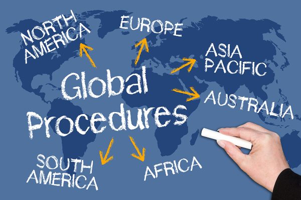 Global,Procedures,Chalkboard,With,Female,Hand,And,World,Map,In